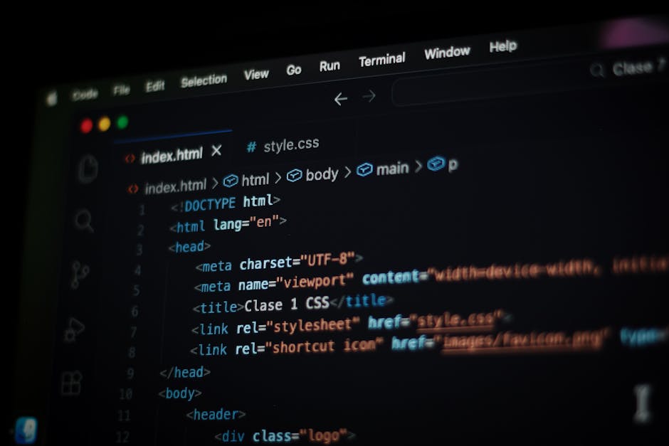 A close-up view of a computer screen displaying lines of HTML code in a text editor, with syntax highlighting in blue, orange, and white. The code includes tags such as <html>, <head>, <title>, and <l