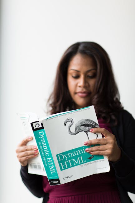There is no image related to gardening, outdoor maintenance, or landscaping features in the provided photo. The image shows a woman with dark hair reading a book titled 'Dynamic HTML' by O'Reilly, wit